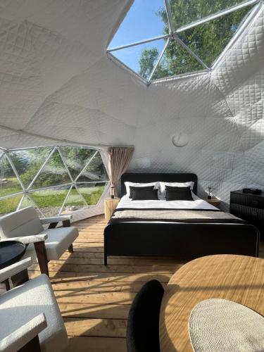 a bedroom with a bed in a tent at Grotto Getaway in Miller Lake
