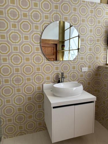 a bathroom with a sink and a mirror at Casa Vega in Cuenca