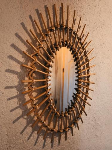 a mirror with a wooden frame on a wall at Exklusives Naturjuwel - Kühbartl Simmerl in Oberhaag