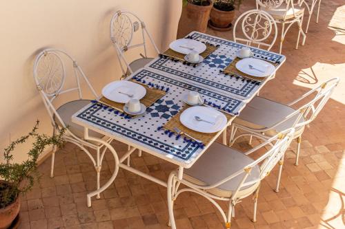 een blauwe en witte tafel en stoelen in een kamer bij Riad Dar Ben Slimane in Marrakesh