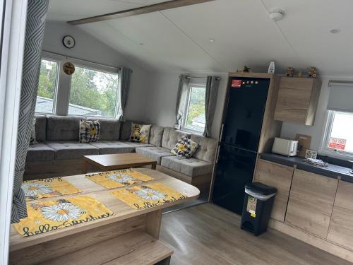 a living room with a couch and a table at HoneyBees At Glade 17 in Bucks Mills