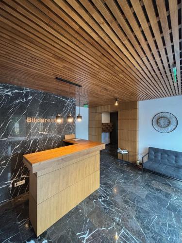 a lobby with a counter and a blue couch at Aviatiei-Boutique in Bucharest