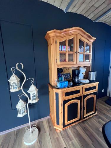 a toy kitchen with a wooden cabinet and a lamp at Wohnen im ehemaligen Kuhstall Stiehler Farm in Treia