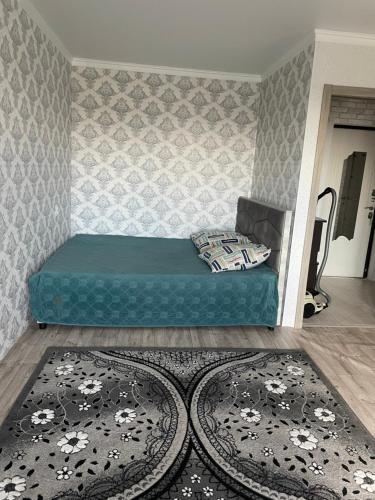 a room with a bed and a rug at Квартира in Borovoye