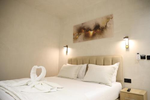 a white bed with a white swan on it at Rooms Kruja City in Krujë