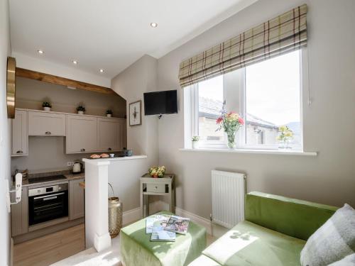 a kitchen with a couch and a table in a room at 1 bed property in Holmfirth 82194 in Meltham