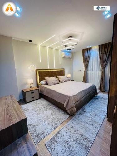a bedroom with a large bed and two windows at Stylish & Trendy in Cairo