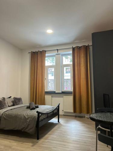 a bedroom with a bed and a large window at New May Apartment in Staré Mesto