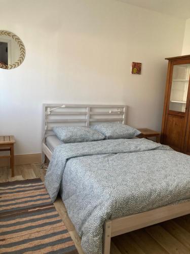 a bedroom with a bed with two pillows on it at Maison Martin de ville de style 6 pers calme terrasse in Mulhouse