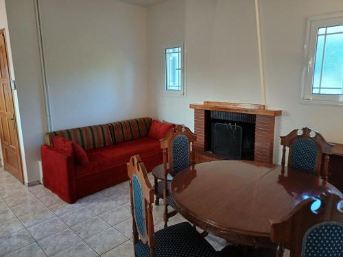 a living room with a table and a couch at Yiannis & Ria's Farm in Kalamata