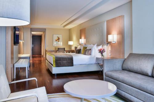 a hotel room with a bed and a couch at Palladio Hotel Buenos Aires - MGallery Collection in Buenos Aires