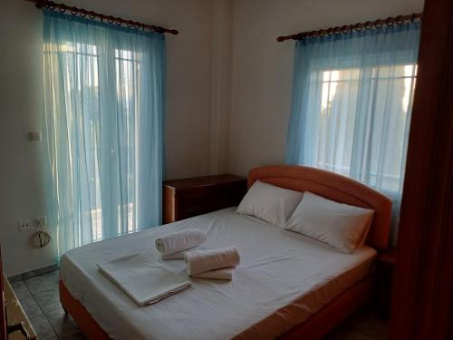 a bedroom with a bed with two towels on it at Yiannis & Ria's Farm in Kalamata