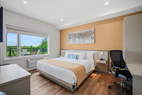 Ένα ή περισσότερα κρεβάτια σε δωμάτιο στο Days Inn by Wyndham Riviere-Du-Loup
