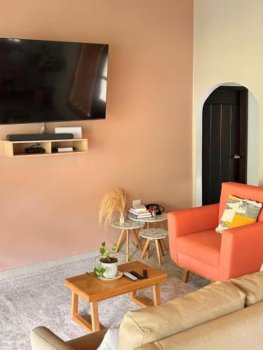a living room with a couch and a table at La Veranda Hotel & Restaurant in Minca