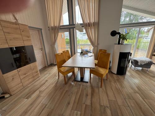 a dining room with a wooden table and chairs at Seeschwalbe 78 Kompassweg in Rechlin
