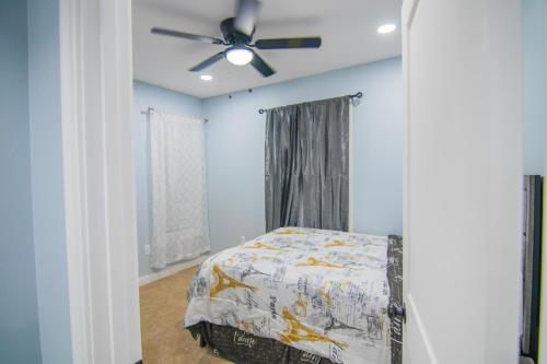 a bedroom with a bed and a ceiling fan at Cozy 2nd & 3rd Floor Retreat in Lewiston