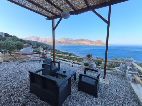 a patio with chairs and a view of the ocean at Sofilia view house in Argilia