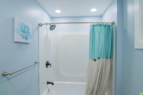 a bathroom with a shower with a shower curtain at Cozy 2nd & 3rd Floor Retreat in Lewiston