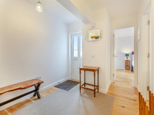 a living room with a bench and a hallway at Sandakan in Ardersier