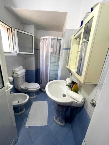 a bathroom with a sink and a toilet at Belvedere Apartment in Vlorë