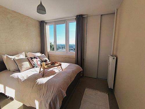 a bedroom with a bed with a table on it at LeRelaisdOdile-Idéal Pro & Famille-Proche Métro-Fort de Mons in Mons-en-Baroeul