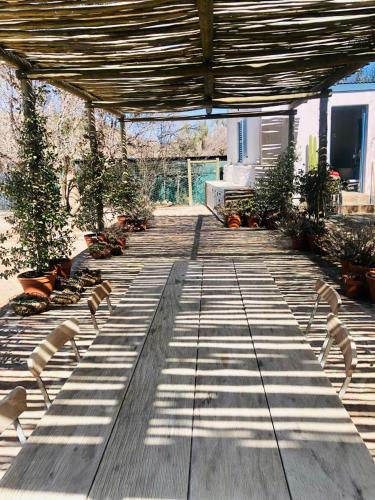 a group of chairs sitting on a wooden deck at Sister Alice in Nieu-Bethesda