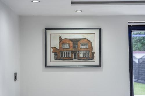 a picture of a house on a wall at Chingford Manor in Chingford