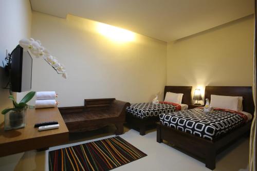 Ένα ή περισσότερα κρεβάτια σε δωμάτιο στο Rai House Sanur