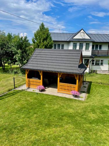 a house with a gazebo in the yard at NOCLEGI ŁĘTOW-SKI in Białka Tatrzanska