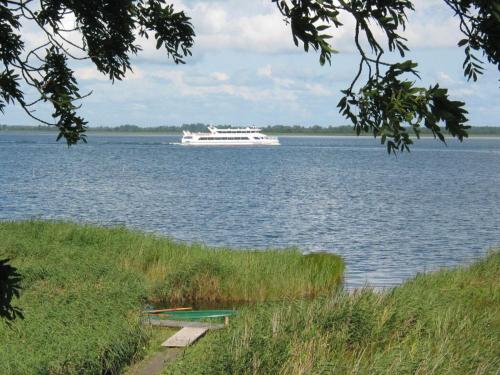 a cruise ship on a large body of water at Holiday home Crane Coast in Kinnbackenhagen