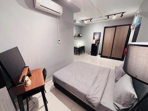 a bedroom with a bed and a desk and a table at Nordic Studio I CityCenter I Netflix I AirPurifier I Segi in Subang Jaya