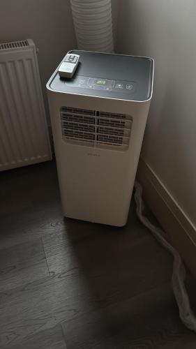 a heater with a cell phone sitting on top of it at Queen Street AC SUITE-Free Wifi& Self Checkin in Toronto