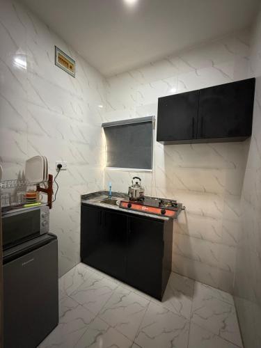 a kitchen with a sink and a counter top at Comfortable Studio apartment in ogudu by Magnanimous apartments in Lagos