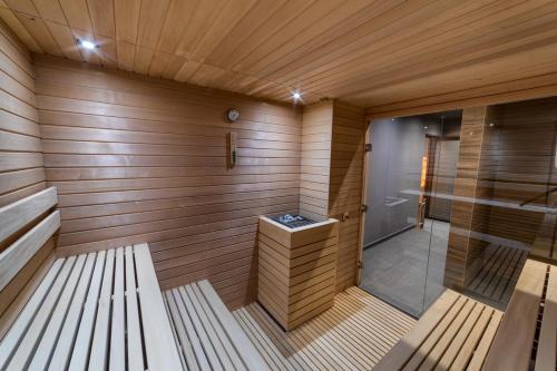 a sauna with a bench in a room with wooden walls at Valor in Zlatibor