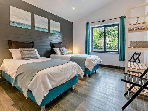 a bedroom with two beds and a window at 3 Bed in Penzance 1.5 mls 75635 in Gulval