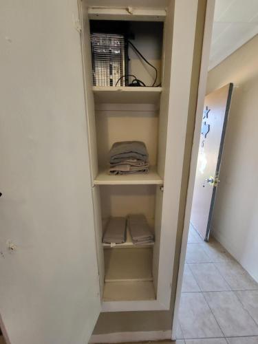 a closet with shelves in a room at Hill Country Lodge and Mini Storages in Buchanan Dam