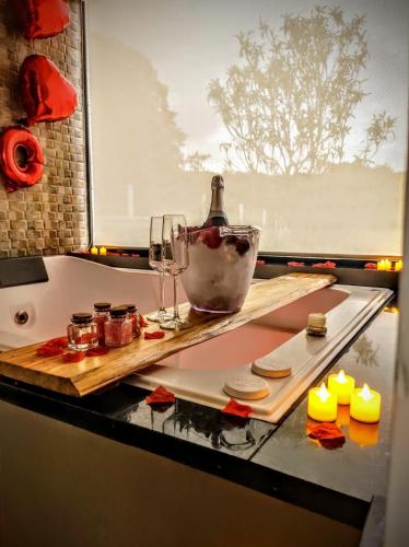 a table with wine glasses and cheese and candles at Cabanas Antonelli in Caxias do Sul