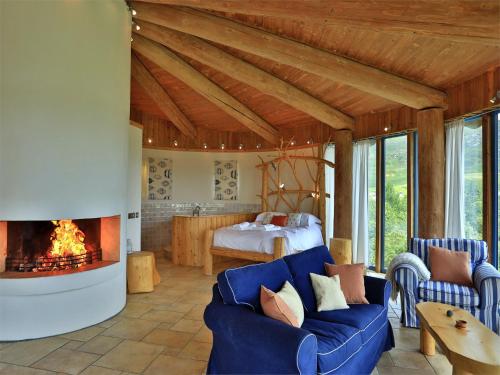 a living room with a blue couch and a fireplace at 1 Bed in Acharacle CA368 in Kilchoan