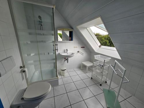 a bathroom with a toilet and a sink and a window at Atlantik in Loperhet