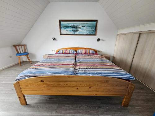 a bed with a wooden frame in a room at Atlantik in Loperhet
