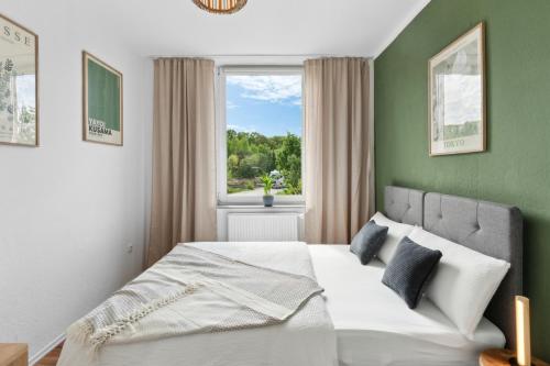 a bedroom with a large bed with a window at Business Apartment Alte Post in Unterlüß