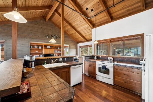 a large kitchen with wooden cabinets and white appliances at The Inn at Manzanita in Manzanita