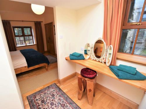 a room with a vanity with a mirror and a bed at 2 bed property in Cairnbaan CA113 in Cairnbaan