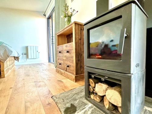a fireplace with a television on top of it at 1 Bed in Bude 88499 in Morwenstow