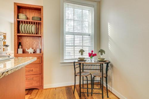 a kitchen with a small table and two stools at Dtwn at Your Door Historic Frederick Gem with Yard! in Frederick