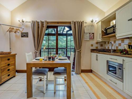 a kitchen with a table and chairs and a window at 1 Bed in Garth BN216 in Garth