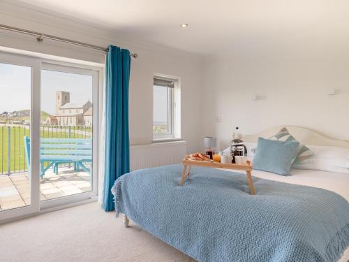 a bedroom with a bed with a table on it at 4 Bed in West Runton 81469 in West Runton