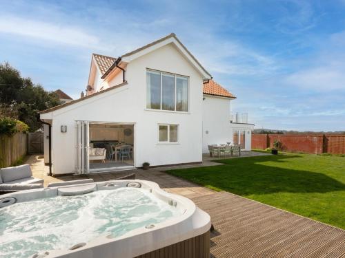 a house with a hot tub in a backyard at 4 Bed in West Runton 81469 in West Runton