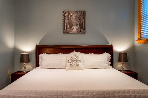 a bedroom with a large white bed with two lamps at Wellness Retreat Zen Oasis DOGS Spa Hot Tub in Cosby