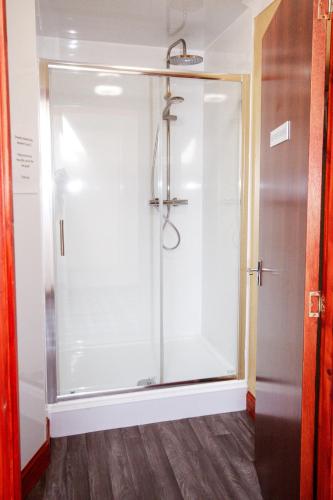 a shower in a bathroom with a glass door at Weston House Keith in Keith